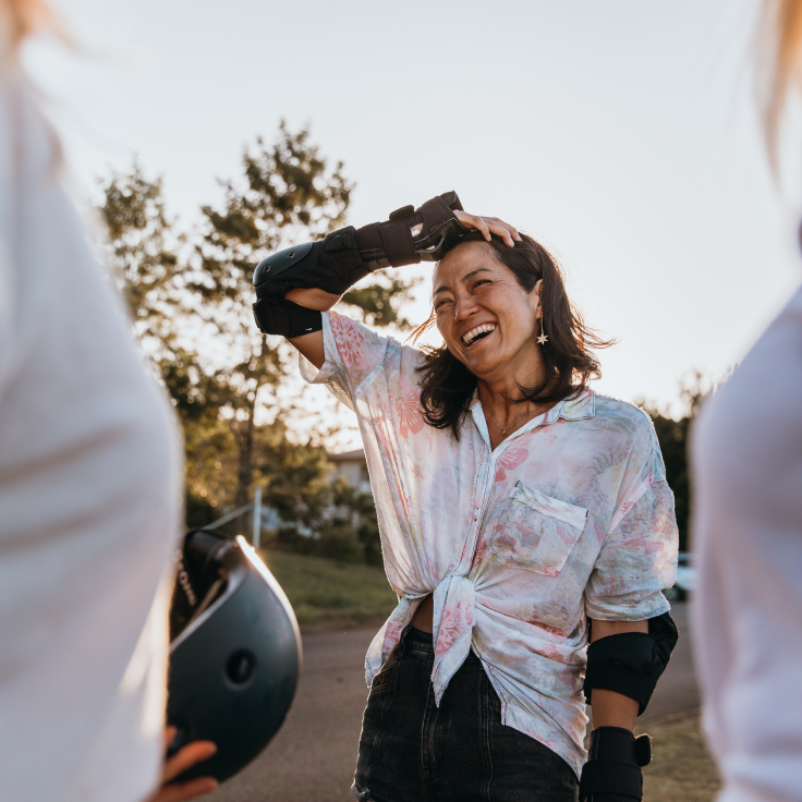 Woman skateboarding with friends