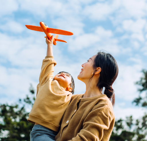 child playing with aeroplane toy